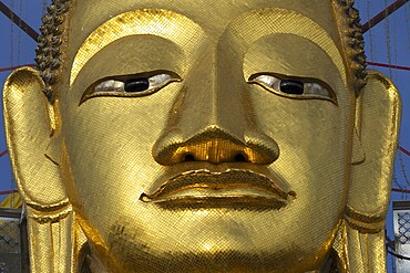 Face of a 32 metre high standing Buddha decorated with glass mosaics and 24-carat gold, Luang Pho To or Phrasiariyametri, Wat Intharawihan, Bangkok, Thailand