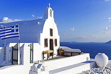 White architecture, orthodox church by the sea, Greek flag, blue sky, Oia, Santorini, Cyclades, Aegean Sea, Greece