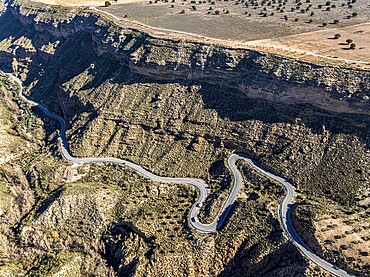 Deep canyon at the Gorafe desert, winding road to village Gorafe, aerial view, Gorafe Desert, UNESCO Granada Geopark, Granada province, Andalusia, Spain