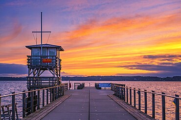 Footbridge at glorious sunset, sky in vivid colours, Glücksburg, Germany