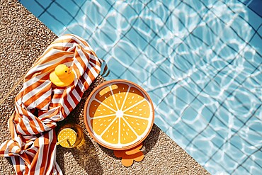Pool edge with orange, summery props