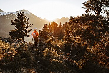 Hiker in the Allgäu at sunset in spring on the Zirmgrat near Pronten in the Allgäu