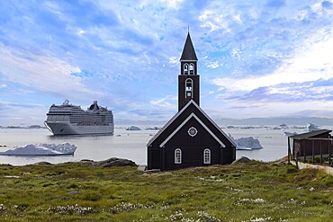 Typical architecture of Greenland Ilulissat with colored houses located near fjords and icebergs