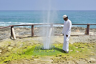 Local man watching Blow Hole in Mughsayl, Dhofar Region, Oman
