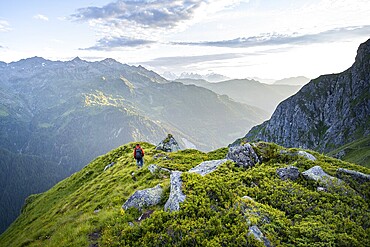 Mountaineers in a picturesque mountain landscape in the atmospheric evening light, view from the Cabane du Louvie, Valais Alps, Val de Bagnes, Valais, Switzerland