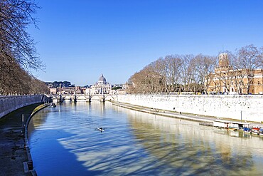 Rome skyline with St Peter's Basilica in the Vatican Ponte Sant'Angelo bridge over the river Tiber in Rome, Italy