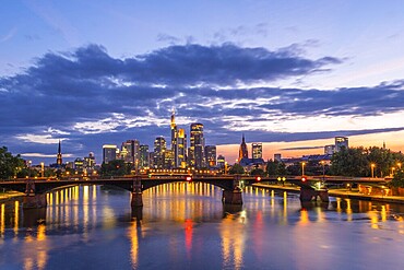 Illuminated Frankfurt City Downtown, Ignatz Bubis Bridge and Main River at Evening Twilight. Hesse, Germany