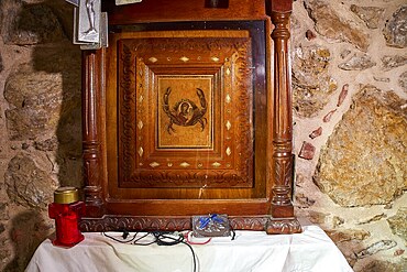 Legend, crab, shell fisherman, wood carving with crab motif in a chapel on an altar with candle, chapel, small church, Agia Kavouradena Monastery, Xirokambos, Leros, Dodecanese, Greek Islands, Greece