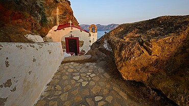 Legend, crab, shell fisherman, stone path to the chapel on the coast, surrounded by rocks, with calming sea view in the evening light, chapel, little church, Agia Kavouradena monastery, Xirokambos, Leros, Dodecanese, Greek Islands, Greece