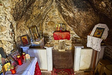 Legend, crab, shell fisherman, sacred interior of a small chapel with icons and candles in a rocky environment, mystical atmosphere, chapel, small church, Agia Kavouradena Monastery, Xirokambos, Leros, Dodecanese, Greek Islands, Greece