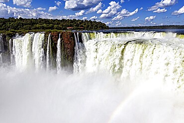 Impressive waterfalls with spraying spray under a cloudy sky, The Iguazu Falls between Argentina and Brazil