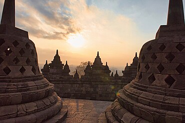 The silhouettes of stupas of the Borobudur temple in the morning light, Candi Borobudur, Borobudur, Java, Indonesia