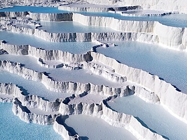 White limestone terraces with turquoise-coloured water under a clear sky, aerial view, sinter terraces, limestone sinter terraces, travertine terraces, Pamukkale, Denizli, UNESCO World Heritage Site, Anatolia, Turkey