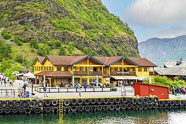 Bustling tourist center at Flam harbor with traditional buildings