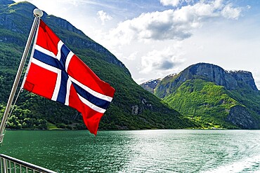 Norwegian flag flying on a ferry in Naeroyfjord