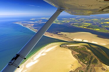 Hiddensee Island, in the background the island of Rügen with rapeseed fields, Mecklenburg-Western Pomerania, Germany, aerial photo from a small aircraft, 27.04.2025  Hiddensee Island, in the background the island of Rügen with rapeseed fields, Mecklenburg-Western Pomerania, aerial photo from a small aircraft, April 27, 2025 ++ Minimum fee 50, - euro ++