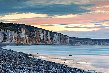 Dramatic cliff landscape with gentle sea coast at sunset with atmospheric sky, The cliffs near Dieppe in Normandy in France
