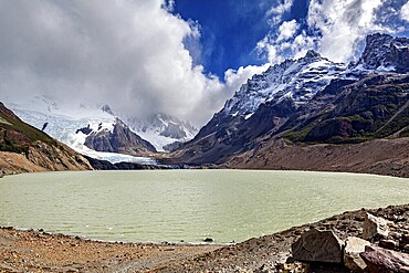 Lake surrounded by snow-capped mountains and glaciers under a cloudy sky, The landscape of Patagonia in Argentina