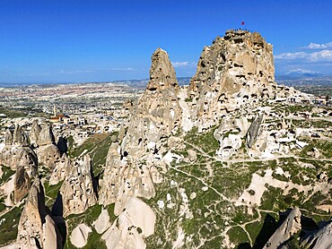 Rocky landscape with ancient rock structures under a clear blue sky in Cappadocia, aerial view, Uchisar Castle, Uçhisar Kalesi, impressive rock formation and fortress, Göreme National Park, Göreme Tarihî Millî, Nevsehir Province, Nevşehir, Cappadocia, Cappadocia, Kapadokya, Cappadocia, Central Anatolia, Turkey