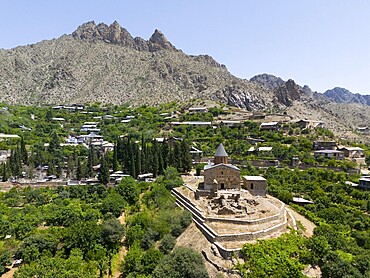 Small historic church on a hill with mountains in the background and lush vegetation, aerial view, St John's Church, Surb Howhannes, Meghruvank Monastery, Basilica, Meghri, Syunik Province, not far from the border with Iran, Armenia, Asia