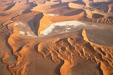 Sand dunes and dry pans in the Namib Desert. In the evening. Aerial view. Namib-Naukluft Park, Namibia