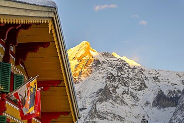 House and Mountain Peak in a Snowy Winter Day in Grindelwald, Bern Canton, Switzerland