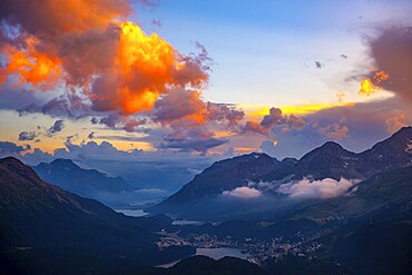 Beautiful Aerial View over Alpine Lakes and Swiss Alps and Cityscape in Sunset and Storm Clouds over St Moritz, Maloja, Grisons, Switzerland