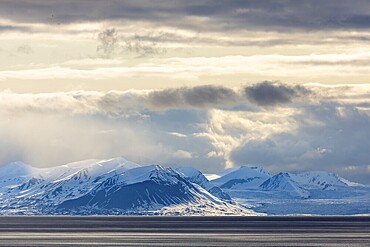 Snow-covered mountains by the sea, clouds, Longyearbyen, Spitsbergen, Svalbard