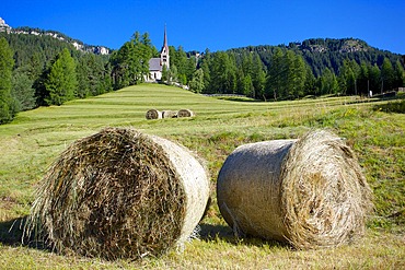 Church and hay bales, Vigo di Fassa, Fassa Valley, Trento Province, Trentino-Alto Adige/South Tyrol, Italian Dolomites, Italy, Europe