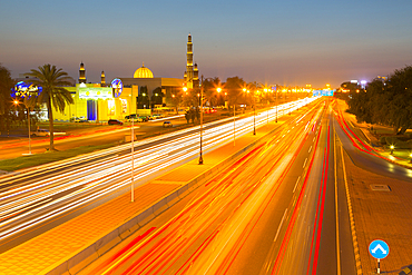 Sultan Qaboos Grand Mosque and traffic on Sultan Qaboos Street at sunset, Muscat, Oman, Middle East