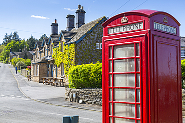 Red telephone box in Beeley Village in springtime, Derbyshire Dales, Derbyshire, England, United Kingdom, Europe