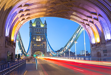 View of North Tower of Tower Bridge and car trail lights at dusk, London, England, United Kingdom, Europe