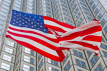 American flag set against skyscraper building windows in Downtown Miami, Miami, Florida, United States of America, North America