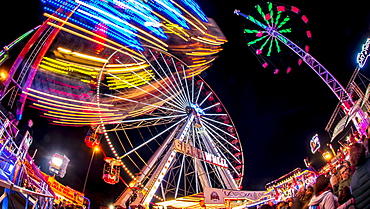 Ferris Wheel and various other funfair rides at night at Nottingham's Goose Fair, Nottingham, Nottinghamshire, England, United Kingdom, Europe