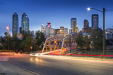 Car trail lights through Macdonal Avenue bridge and Downtown skyline at dusk, Calgary, Alberta, Canada, North America