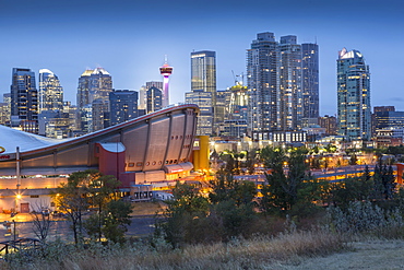 View of the Saddledome and Downtown skyline from Scottsman Hill at dusk, Calgary, Alberta, Canada, North America