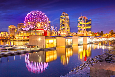 View of False Creek and Vancouver skyline, including World of Science Dome at dusk, Vancouver, British Columbia, Canada, North America