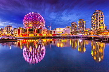 View of False Creek and Vancouver skyline, including World of Science Dome at dusk, Vancouver, British Columbia, Canada, North America