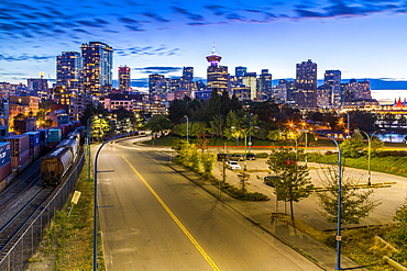 View of city skyline and Vancouver Lookout Tower at dusk from Portside, Vancouver, British Columbia, Canada, North America