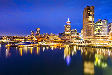 City skyline including Vancouver Lookout Tower as viewed from Canada Place at dusk, Vancouver, British Columbia, Canada, North America