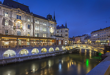 View of Triple Bidge across Ljubljanica River from Plaza Presernov at dusk, Ljubljana, Slovenia, Europe