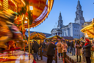 View of carousel and Christmas Market stalls at Christmas Market, Millennium Square, Leeds, Yorkshire, England, United Kingdom, Europe