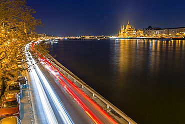 Trail lights along River Danube and Hungarian Parliament Building at night, Budapest, Hungary, Europe