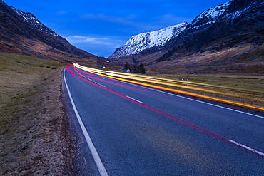 View of road through the Glencoe Valley at dusk, Glencoe, Highland Region, Scotland, United Kingdom, Europe