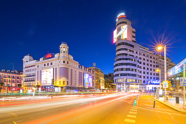 View of architecture and trail lights on Gran Via and Plaza del Calao at dusk, Madrid, Spain, Europe