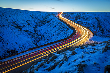 Winter landscape and trail lights on Snake Pass, Peak District National Park, Derbyshire, England, United Kingdom, Europe