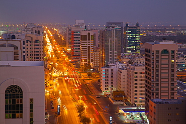 City skyline and Rashid Bin Saeed Al Maktoum Street at dusk, Abu Dhabi, United Arab Emirates, Middle East