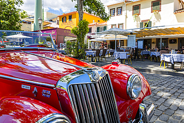 View of red vintage MG car in front of traditional Al Fresco restaurant in old town, Funchal, Madeira, Portugal, Europe