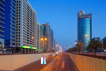 City skyline on Rashid Bin Saeed Al Maktoum Street at dusk, Abu Dhabi, United Arab Emirates, Middle East