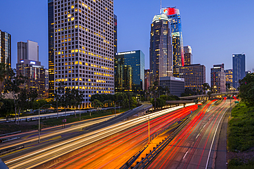 View of Downtown skyline and Harbour Freeway at dusk, Los Angeles, California, United States of America, North America